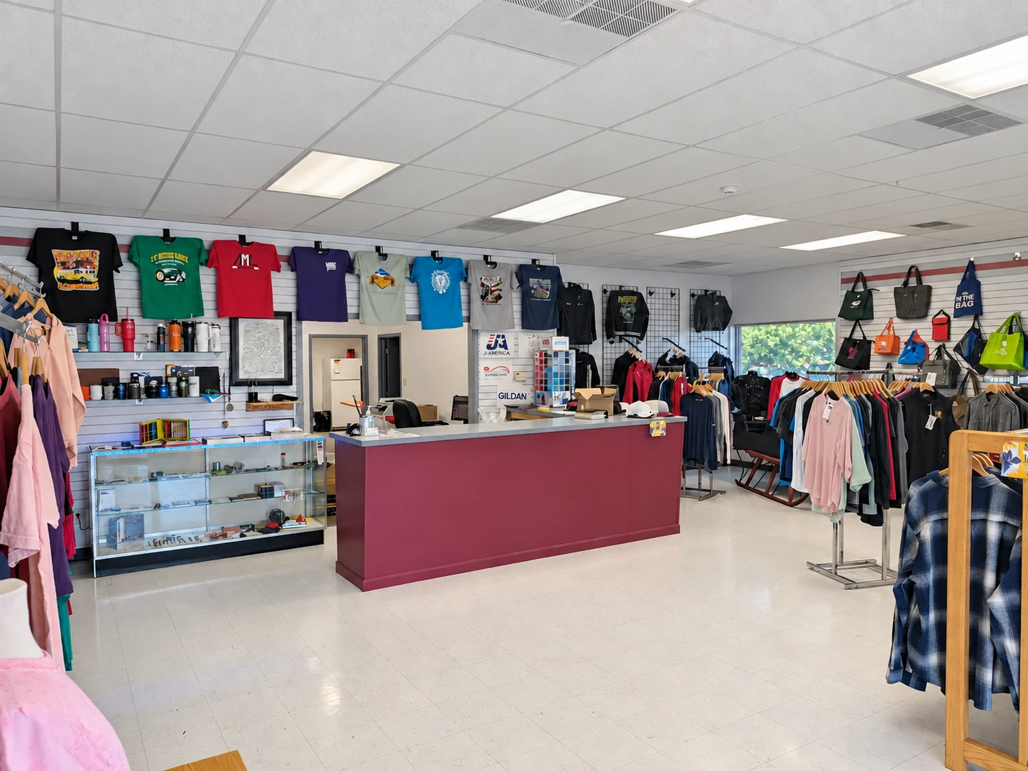 Edited photo: Del Print’s showroom with its burgundy counter, sample apparel, and display cases